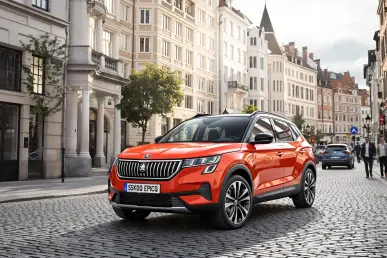 La Skoda Epiq électrique stationnée dans une rue pavée d'une ville européenne, illuminée par le soleil.